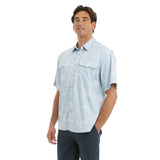 Man wearing a light blue patterned shirt with short sleeves