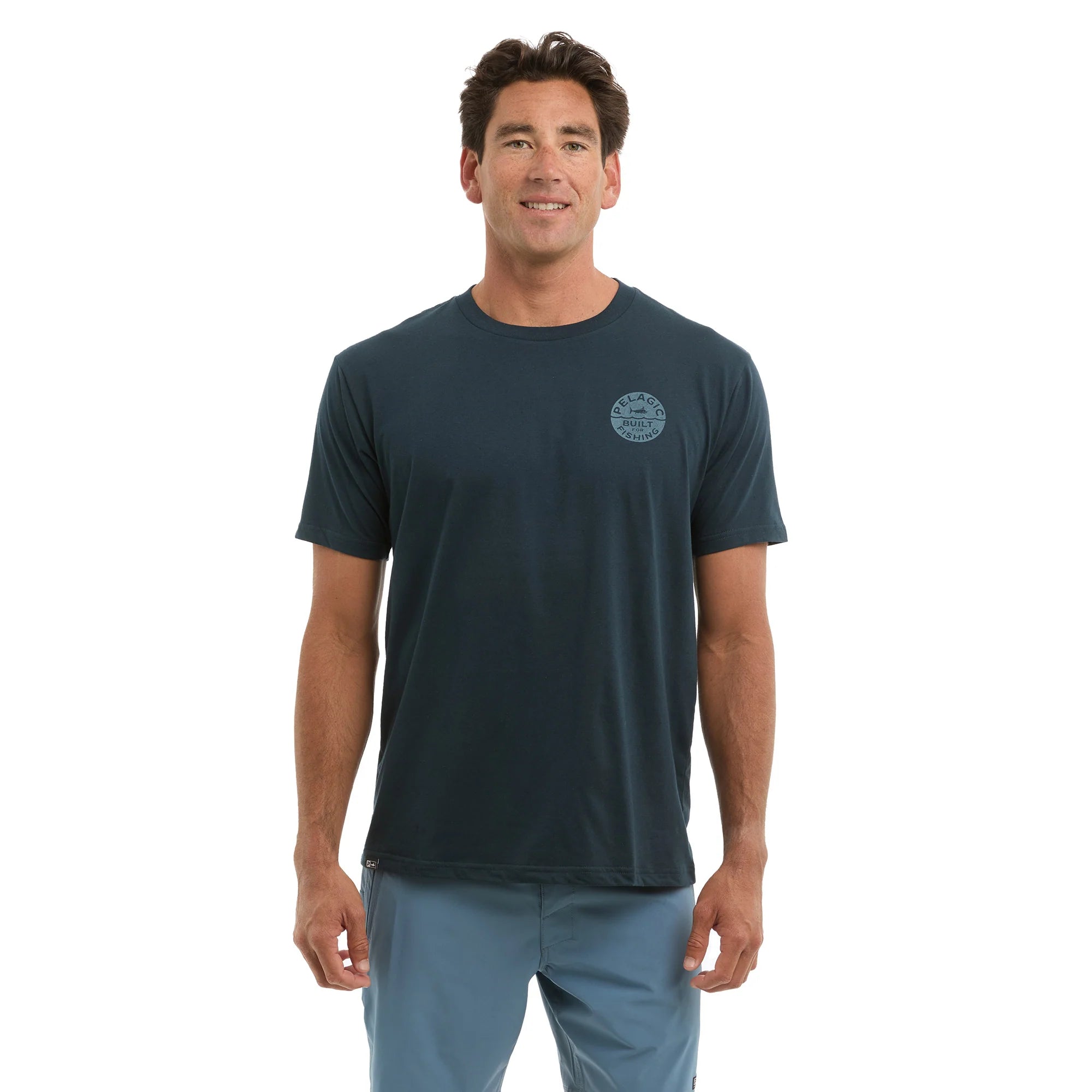 Man wearing a dark blue t-shirt with a Pelagic logo on a white background