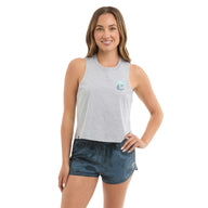 Woman wearing a gray sleeveless top and blue shorts on a white background