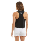 Woman wearing a black sleeveless top and white shorts on a white background