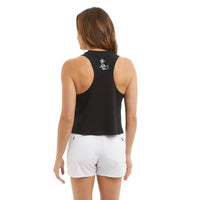 Woman wearing a black sleeveless top and white shorts on a white background