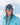 Person wearing a blue cap and sunglasses with a clear sky background